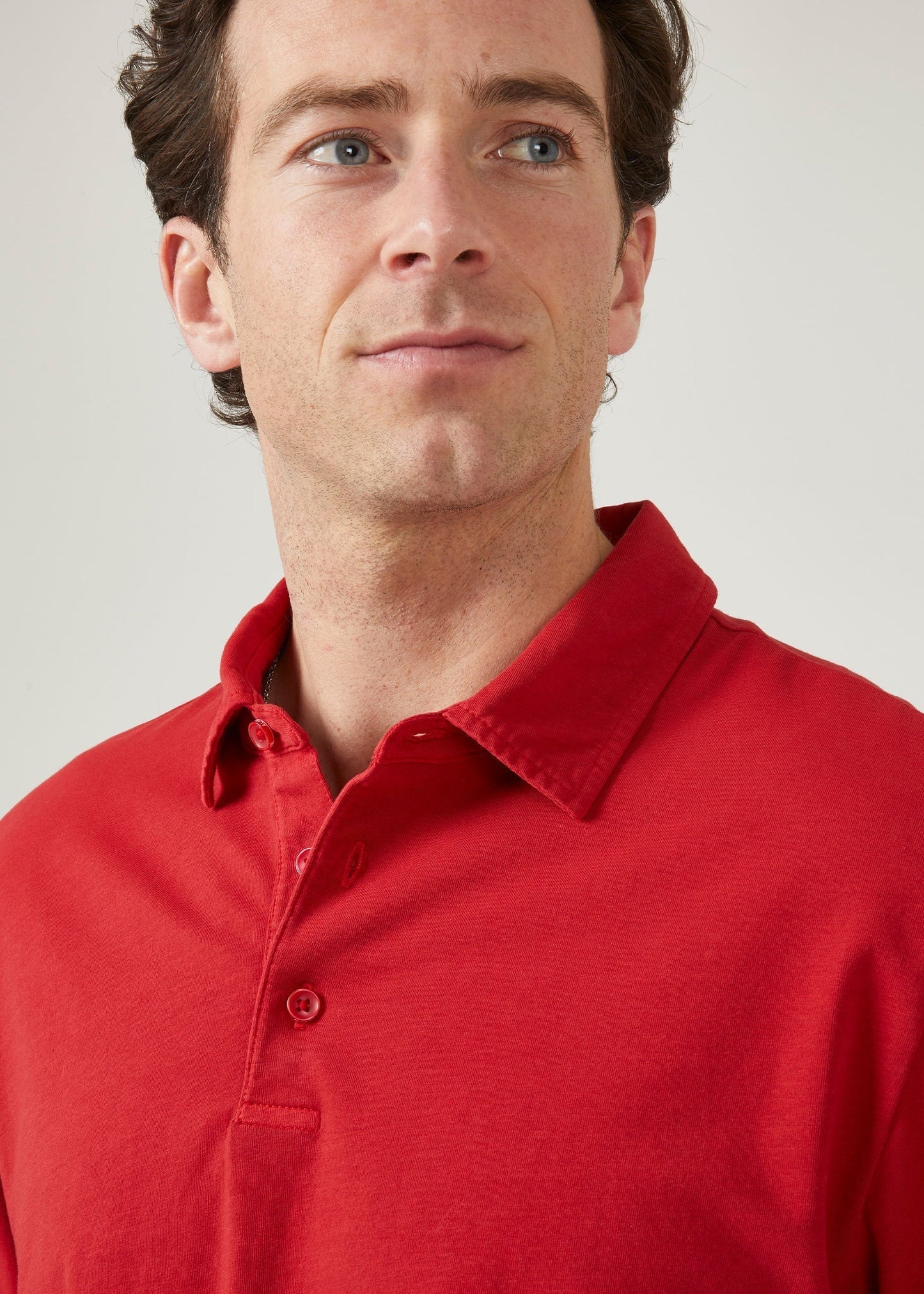 Faded dye polo shirt in rosso red made from a cotton/ spandex blend.